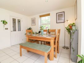 A dining room with a wooden table and chairs at Manning's View Barnstaple