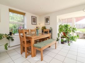 A dining room with a table and chairs at Manning's View Barnstaple
