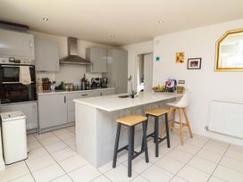 A kitchen with modern appliances and a bar area at Manning's View in Barnstaple