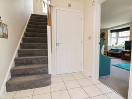 A hallway with stairs and a door at Manning's View Barnstaple