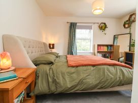 A bedroom with a bed and bookshelf at Manning's View in Barnstaple