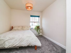 A bedroom with a bed and a window at Manning's View Barnstaple