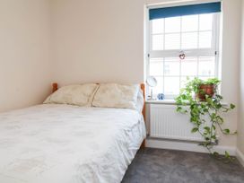 A bedroom with a bed and window at Manning's View in Barnstaple