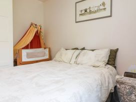 A bedroom with a bed and a crib at Manning's View in Barnstaple