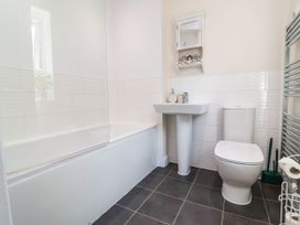 A bathroom featuring a bath tub, sink, and toilet at Manning's View in Barnstaple