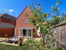 A garden with an apple tree and patio furniture at Manning's View in Barnstaple