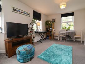 A living room with a television and a dining table at Manning's View in Barnstaple