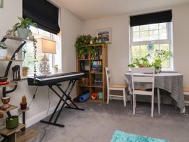 A dining room with a keyboard and plants at Manning's View Barnstaple