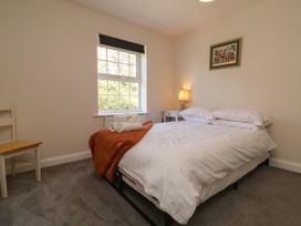 A bedroom with a bed and bedside table at Manning's View Barnstaple