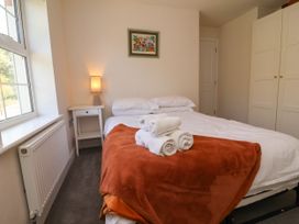 A bedroom with a bed and side table at Manning's View in Barnstaple