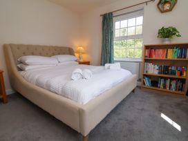 A bedroom with a bed and a bookshelf at Manning's View in Barnstaple