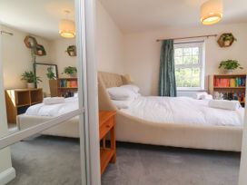 A bedroom with a bed and bookshelf at Manning's View in Barnstaple