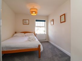 A bedroom with a bed and window at Manning's View in Barnstaple