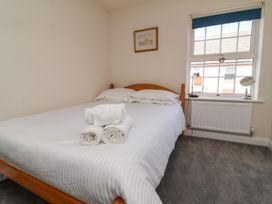 A bedroom with a bed and towels on the bed at Manning's View in Barnstaple
