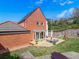 A garden with a house and patio area at Manning's View in Barnstaple