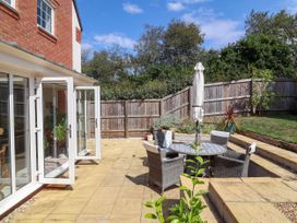 A garden with a table and chairs and an umbrella at Manning's View in Barnstaple