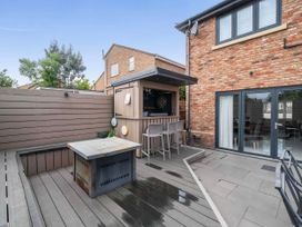 An outdoor area featuring a bar and seating at The Old Barn in Abergele