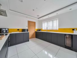 A kitchen with appliances and a window at The Old Barn in Abergele