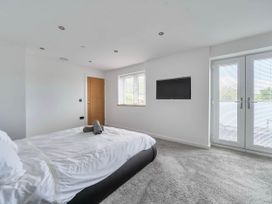 A bedroom with a bed and television at Abergele