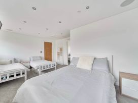 A bedroom with beds and a dresser at Abergele