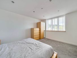 A bedroom with a bed and dresser at The Old Barn in Abergele