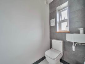 A bathroom with a toilet and sink at The Old Barn in Abergele