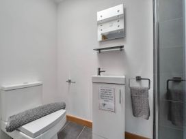 A bathroom with a toilet and sink at The Old Barn in Abergele