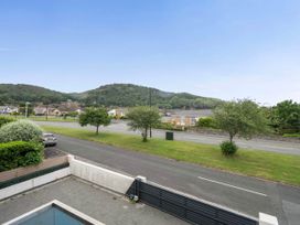 A view of houses and mountains from a balcony at Abergele
