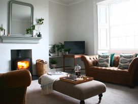 A living room with a sofa, armchair, coffee table, and television at Beautiful 6Bed Sleeps 12 Stunning Views Lynton
