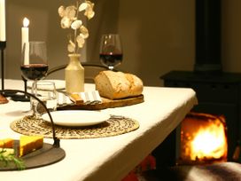 A dining table with bread, cheese, and wine glasses at Beautiful 6Bed Sleeps 12 Stunning Views, Lynton