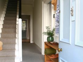 A hallway with stairs and a shelf at Beautiful 6Bed Sleeps 12 Stunning Views in Lynton