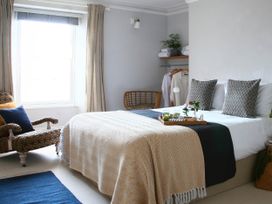 A bedroom with a bed and chair at Beautiful 6Bed Sleeps 12 Stunning Views in Lynton