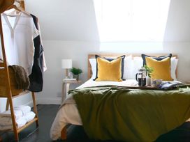 A bedroom with a bed and clothes rack at Beautiful 6Bed Sleeps 12 Stunning Views in Lynton