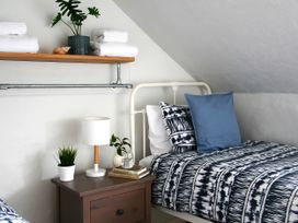 A bedroom with a bed, nightstand, and shelf at Beautiful 6Bed Sleeps 12 Stunning Views in Lynton
