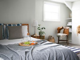 A bedroom with a bed, table and plant at Beautiful 6Bed Sleeps 12 Stunning Views in Lynton