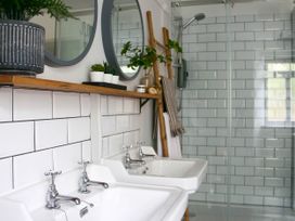 A bathroom with dual washbasins and a shower at Beautiful 6Bed Sleeps 12 Stunning Views in Lynton