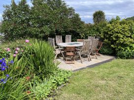 A table and chairs surrounded by plants in a garden at Beautiful 6Bed Sleeps 12 Stunning Views Lynton