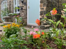 A garden with flowers and a door at 1 bed cottage Parking Patio close to coasts Coads Green near Launceston