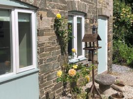 An outdoor view featuring a birdhouse and roses at 1 bed cottage Parking Patio close to coasts Coads Green near Launceston