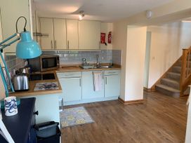 A kitchen with appliances and dining items at 1 bed cottage Parking Patio close to coasts Coads Green near Launceston
