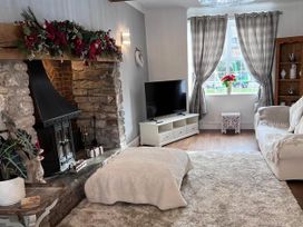 A living room with a fireplace and television at Build your memories hot tub garden sleeps 14 Nottage