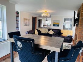 A living room with a dining area and sofa at Build your memories hot tub garden sleeps 14 Nottage