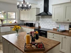 A kitchen with a countertop, sink, and various food items at Build your memories hot tub garden sleeps 14 in Nottage