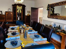 A dining room with a table set for a meal at Build your memories hot tub garden sleeps 14 Nottage
