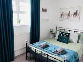 A bedroom with a bed and pillows at Build your memories hot tub garden sleeps 14 Nottage