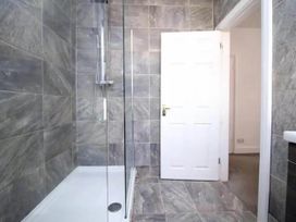 A bathroom with a shower and a door at Build your memories hot tub garden sleeps 14 Nottage