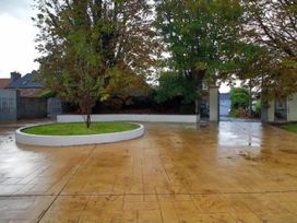 An outdoor area with a central tree and paved flooring at Build your memories hot tub garden sleeps 14 Nottage