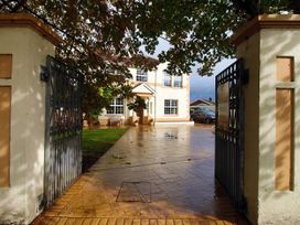 An exterior view of a house with a driveway and gate at Build your memories hot tub garden sleeps 14 Nottage
