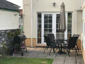 An outdoor seating area with a table and chairs at Build your memories hot tub garden sleeps 14 in Nottage