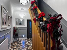 A hallway with a staircase and decorative elements at Build your memories hot tub garden sleeps 14 Nottage